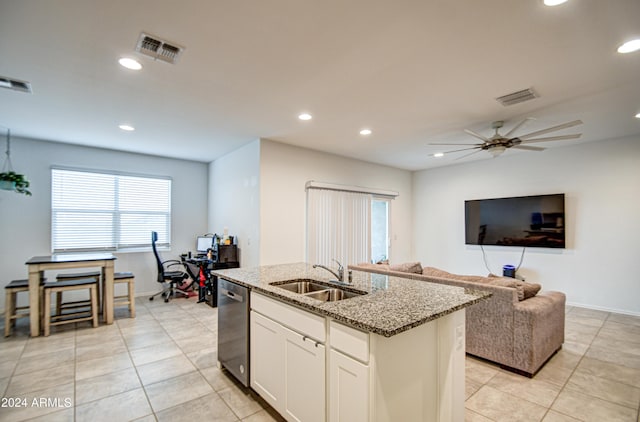 kitchen with visible vents, white cabinets, a sink, an island with sink, and dishwasher