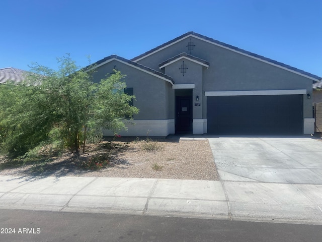 ranch-style house featuring driveway, a garage, and stucco siding