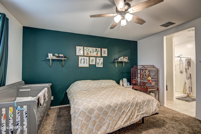 carpeted bedroom featuring a ceiling fan, tile patterned flooring, visible vents, and baseboards