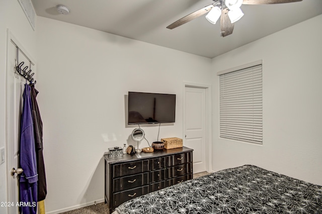 carpeted bedroom with baseboards and a ceiling fan