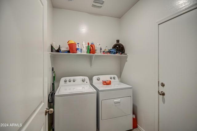 clothes washing area with laundry area, separate washer and dryer, and visible vents