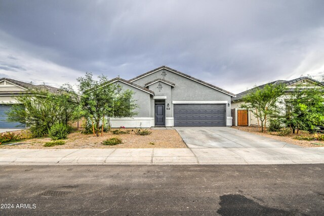 view of front of property with a garage, driveway, and stucco siding