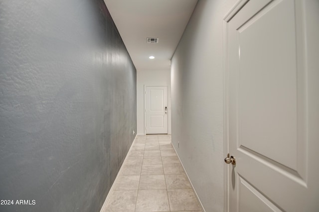 hall with visible vents and light tile patterned flooring