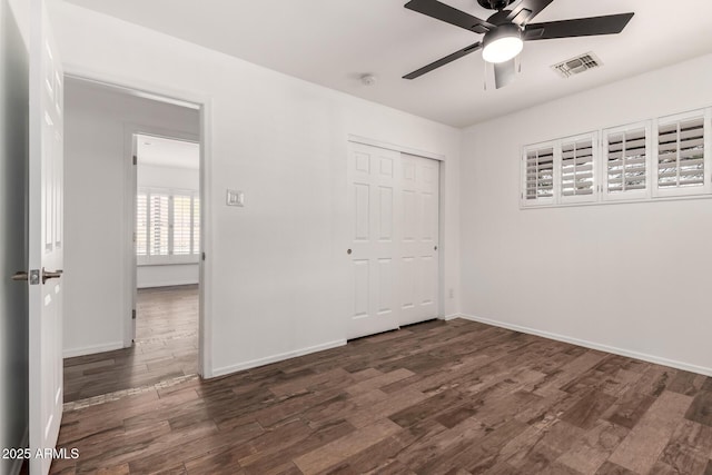 538 W 13th St, Tempe, AZ 85281 - unfurnished bedroom featuring dark wood finished floors, baseboards, a closet, and ceiling fan