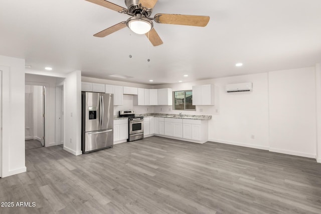 538 W 13th St, Tempe, AZ 85281 - kitchen with appliances with stainless steel finishes, a wall mounted AC, recessed lighting, ceiling fan, and light wood-style flooring