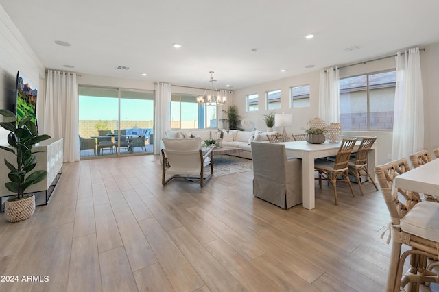 living area with a notable chandelier, recessed lighting, visible vents, and light wood-type flooring
