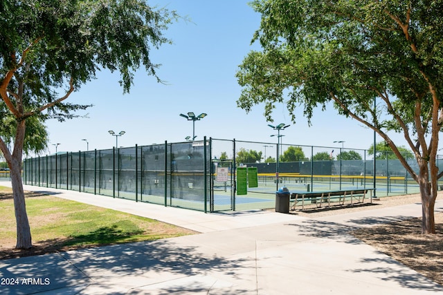 view of tennis court featuring a gate and fence