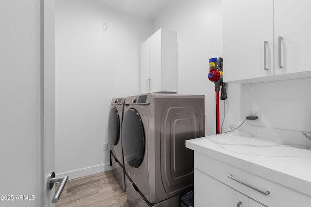 1807 E Campbell Ave, Phoenix, AZ 85016 - washroom with washing machine and clothes dryer, cabinet space, and light wood-type flooring