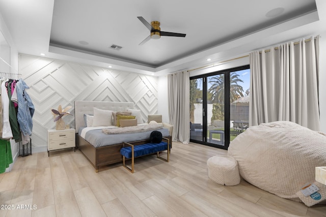 1807 E Campbell Ave, Phoenix, AZ 85016 - bedroom with access to outside, light wood-type flooring, a tray ceiling, a decorative wall, and a ceiling fan