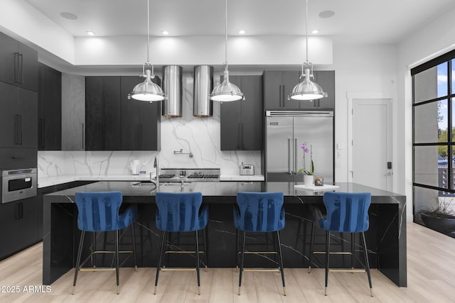 1807 E Campbell Ave, Phoenix, AZ 85016 - kitchen with appliances with stainless steel finishes, dark cabinetry, backsplash, and modern cabinets