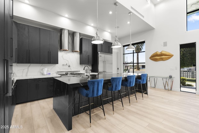 1807 E Campbell Ave, Phoenix, AZ 85016 - kitchen with dark cabinets, built in refrigerator, healthy amount of natural light, a breakfast bar area, and recessed lighting