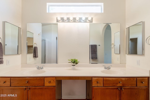 full bathroom with a sink and double vanity