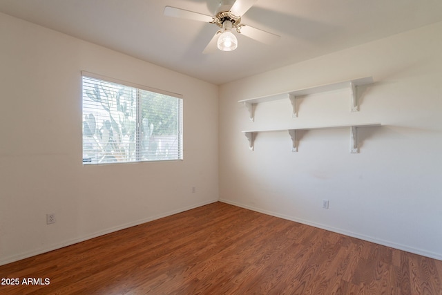 empty room featuring baseboards, a ceiling fan, and wood finished floors