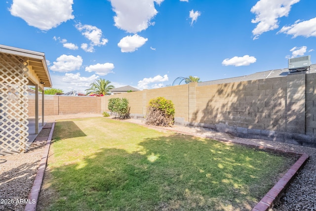 view of yard with central AC unit and a fenced backyard