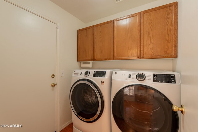 laundry room with cabinet space and washer and clothes dryer