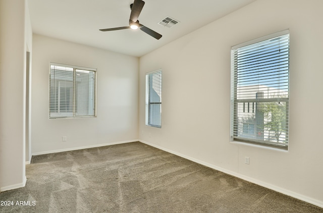 carpeted empty room featuring ceiling fan