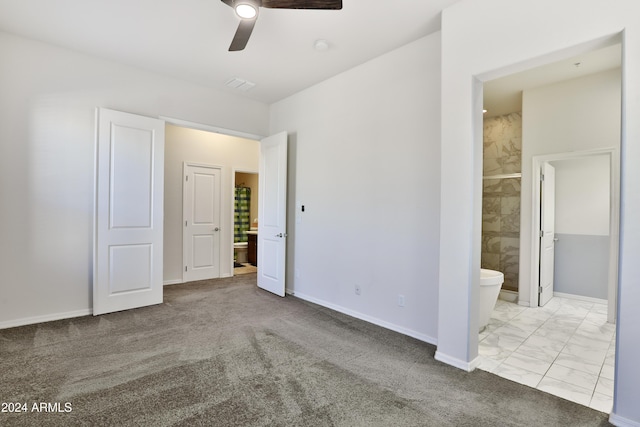 unfurnished bedroom featuring connected bathroom, light carpet, and ceiling fan