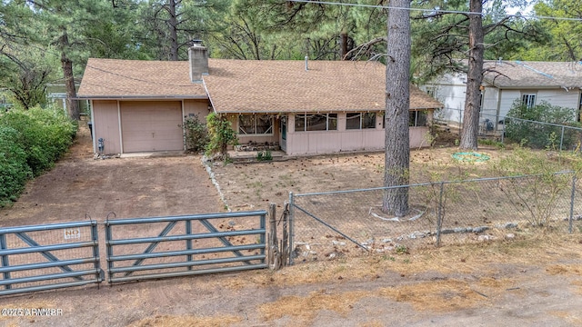 2257 Curry Ln, Lakeside, AZ 85929 - ranch-style home featuring dirt driveway, an attached garage, a chimney, a gate, and a shingled roof