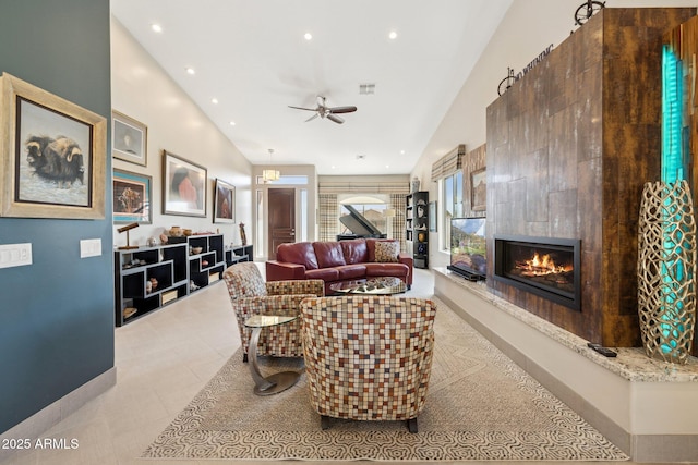 living room with baseboards, a ceiling fan, a premium fireplace, tile patterned flooring, and recessed lighting