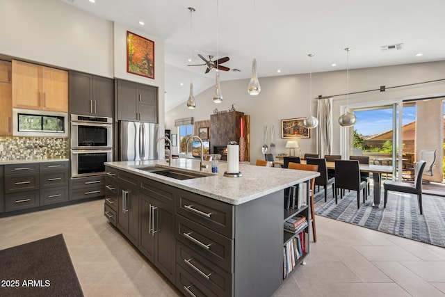 kitchen with tasteful backsplash, visible vents, stainless steel appliances, open shelves, and a sink