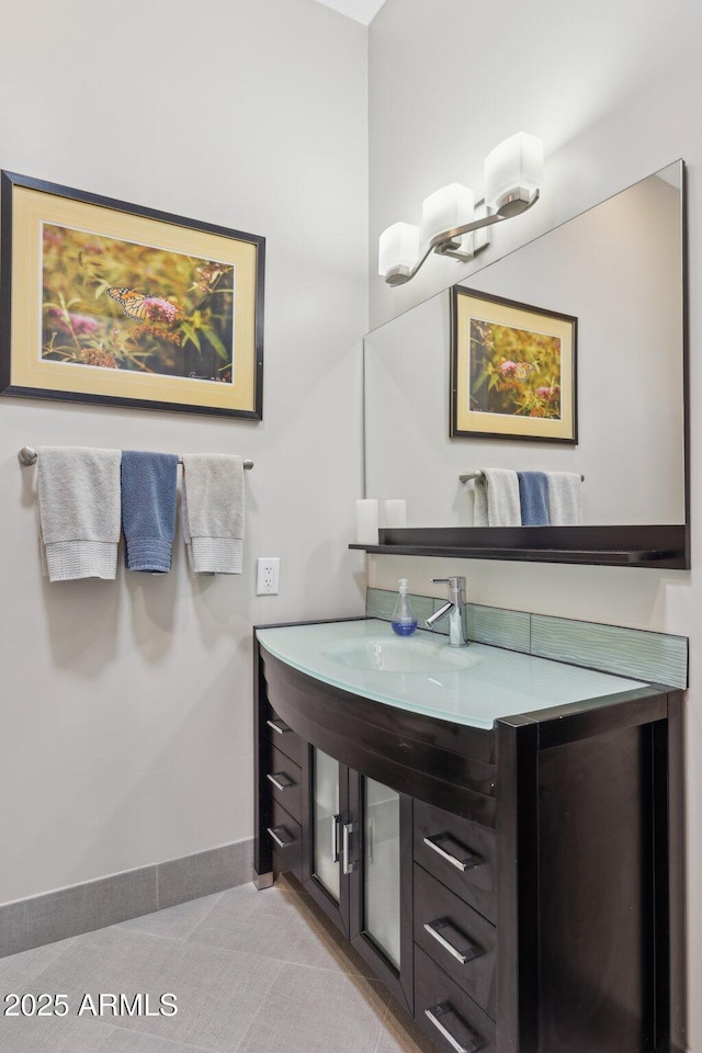 bathroom with a sink and baseboards