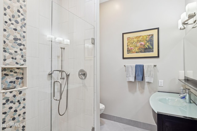 bathroom featuring baseboards, toilet, a shower stall, and vanity