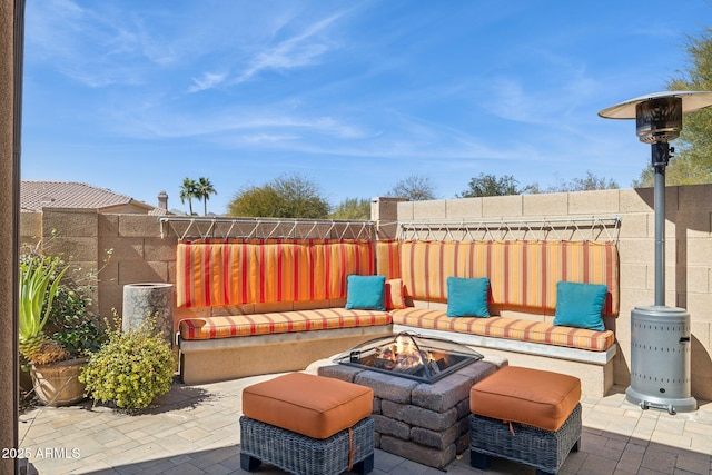 view of patio featuring an outdoor fire pit and fence