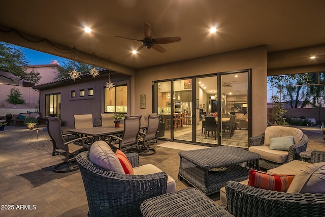 view of patio / terrace with outdoor dining area, a ceiling fan, and an outdoor living space