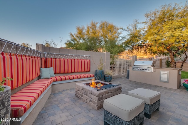 view of patio / terrace featuring a fire pit, area for grilling, and a fenced backyard