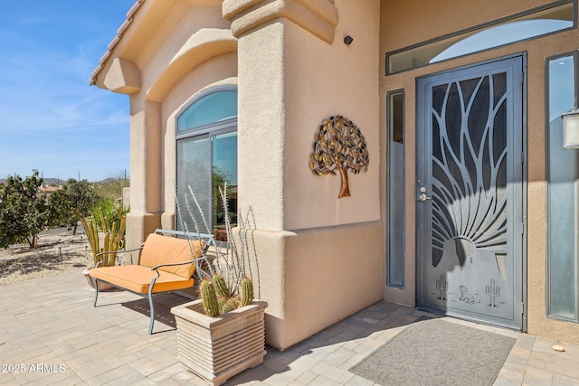 property entrance featuring stucco siding