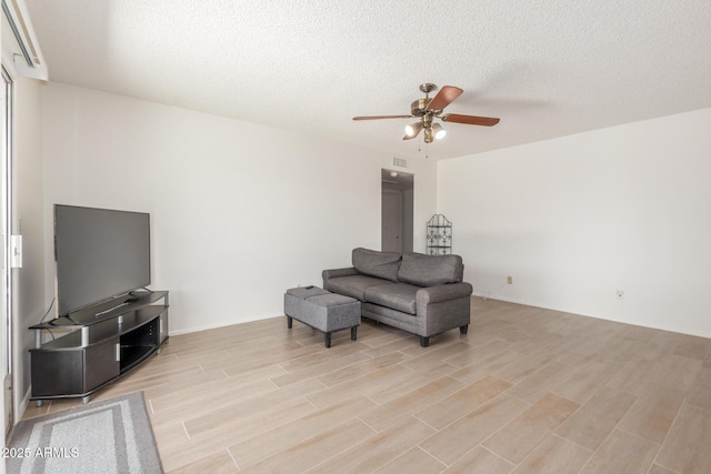 2031 W Gila Ln, Chandler, AZ 85224 - living area featuring ceiling fan, light wood finished floors, and a textured ceiling
