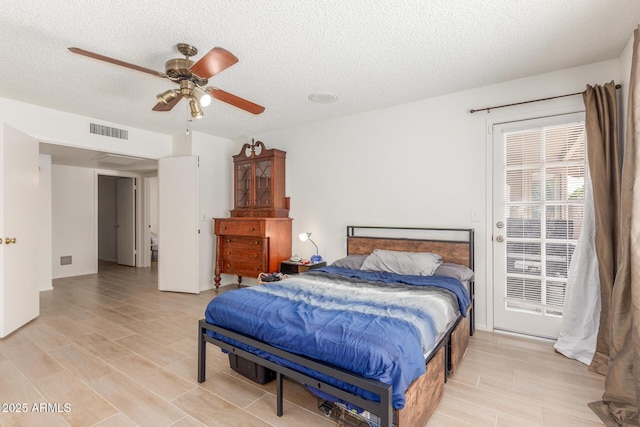 2031 W Gila Ln, Chandler, AZ 85224 - bedroom featuring a textured ceiling, access to exterior, ceiling fan, and light wood-style flooring