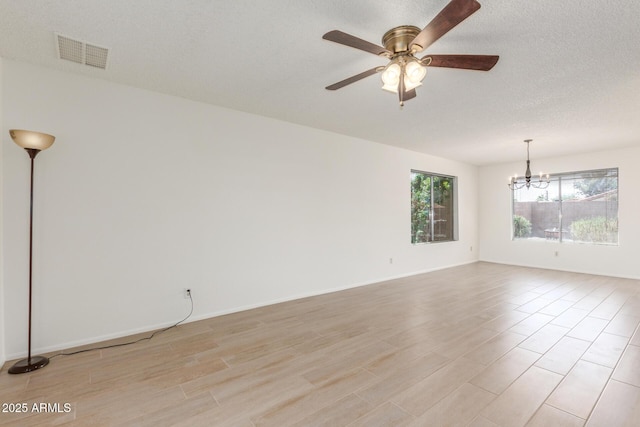 2031 W Gila Ln, Chandler, AZ 85224 - empty room featuring a chandelier, light wood-type flooring, a ceiling fan, baseboards, and a textured ceiling