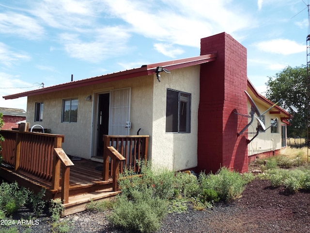 rear view of house featuring a deck