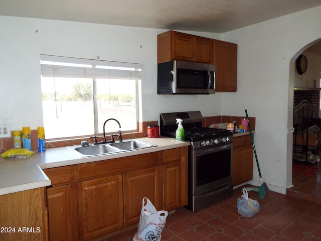 kitchen featuring gas range oven and sink