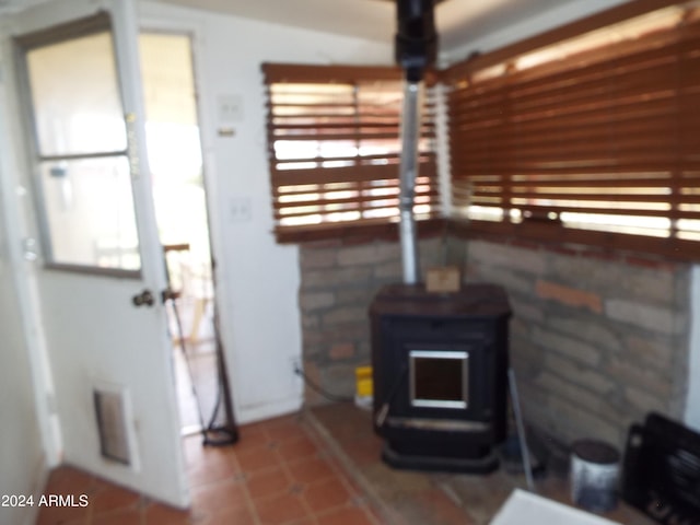 living room with a wealth of natural light and a wood stove