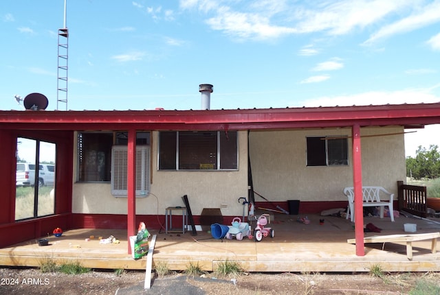 rear view of house with a wooden deck