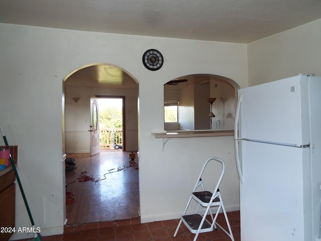 kitchen with dark hardwood / wood-style floors and white refrigerator