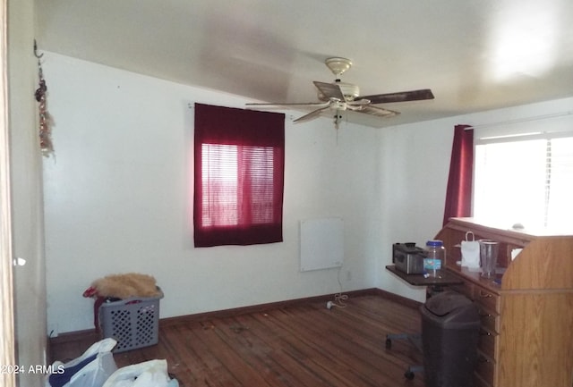 home office featuring dark hardwood / wood-style floors and ceiling fan