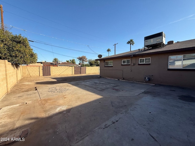 view of yard with central AC and a patio area