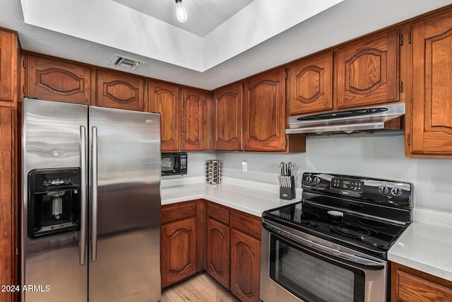 kitchen featuring stainless steel appliances and light hardwood / wood-style floors