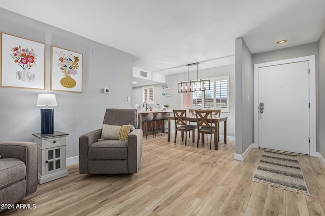 interior space with an inviting chandelier and light wood-type flooring