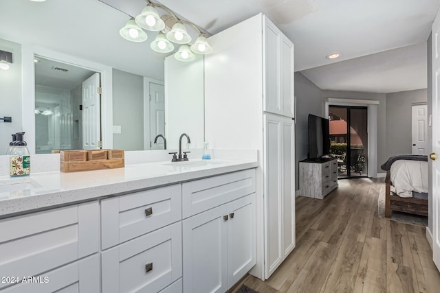 bathroom with vanity and hardwood / wood-style flooring