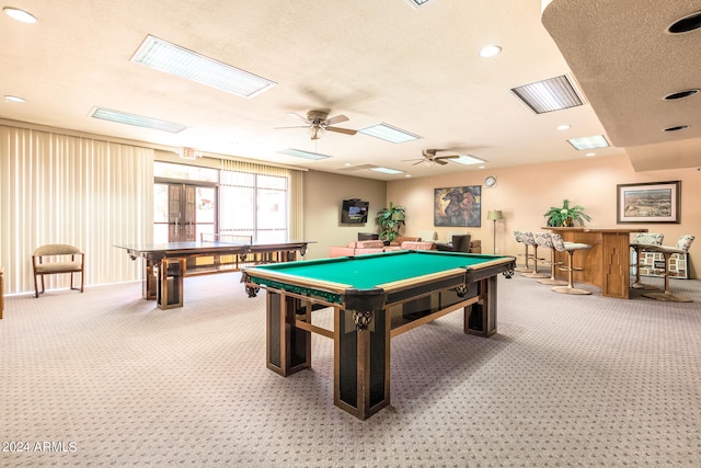 game room with pool table, indoor bar, carpet flooring, a textured ceiling, and ceiling fan