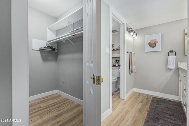 spacious closet featuring light hardwood / wood-style floors