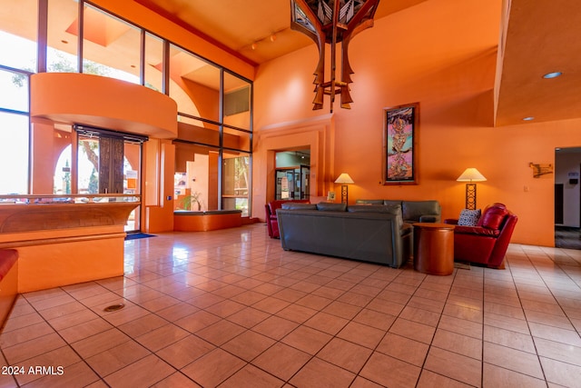 unfurnished living room featuring light tile patterned flooring and a high ceiling