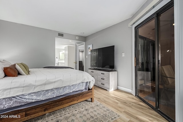 bedroom featuring light hardwood / wood-style floors and access to outside