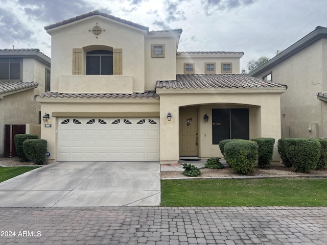 mediterranean / spanish home featuring a garage