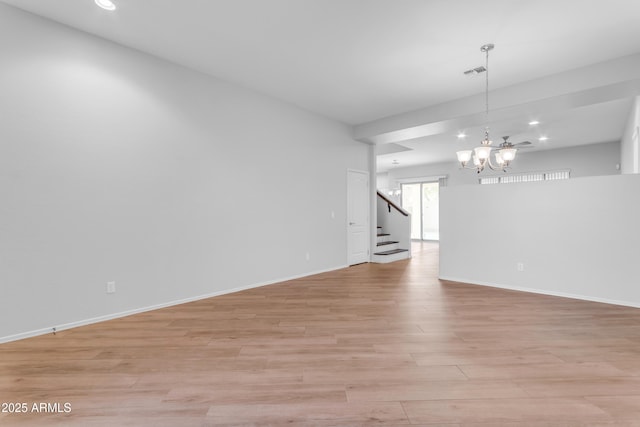 unfurnished room with light hardwood / wood-style flooring and a chandelier