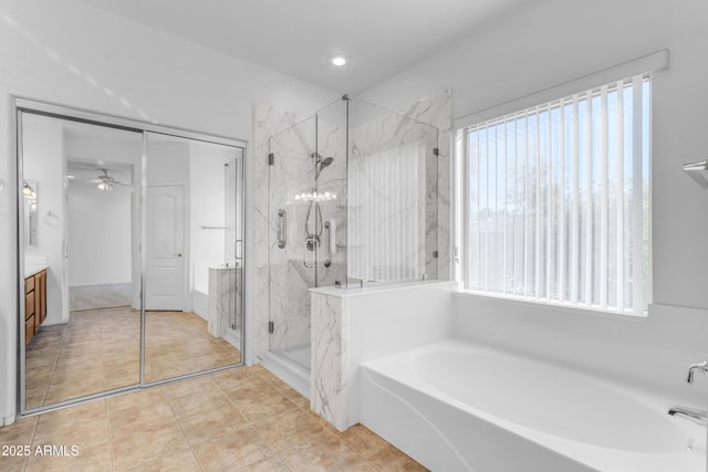 bathroom with independent shower and bath, tile patterned flooring, a wealth of natural light, and vanity